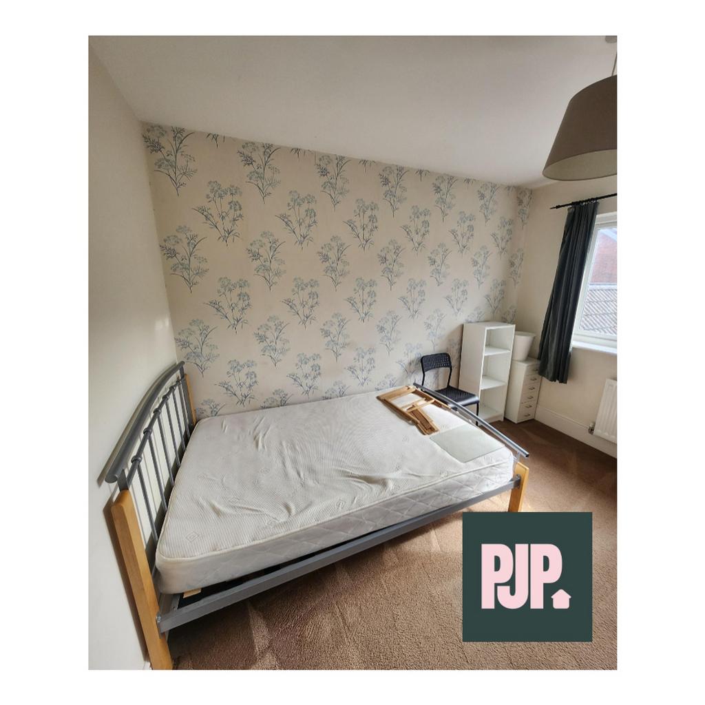 A spacious and bright double bedroom with a ple...