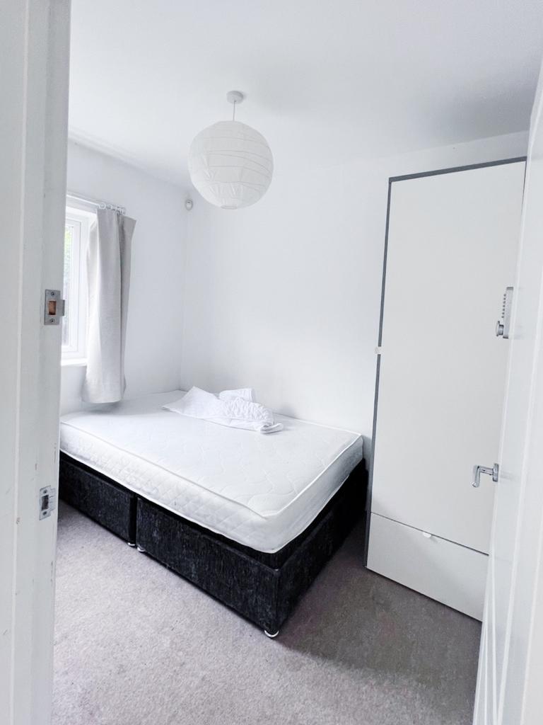 Bright, simply styled bedroom with a comfortabl...