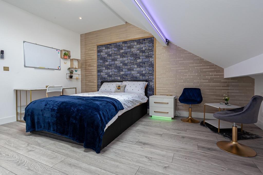 A spacious and stylish large double bedroom, fe...