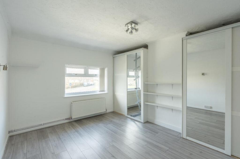 A spacious and bright double bedroom featuring ...