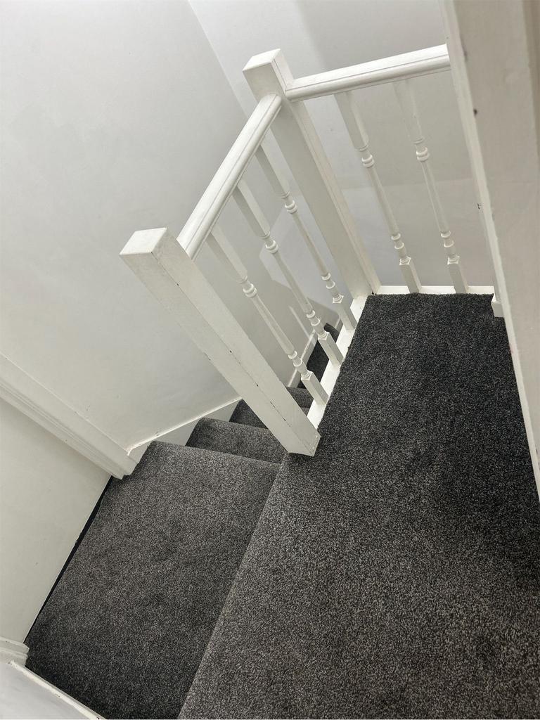 A clean and well-maintained staircase with a mo...