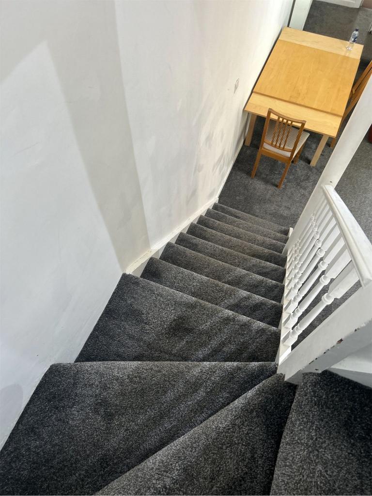 A well-maintained staircase leading to a bright...