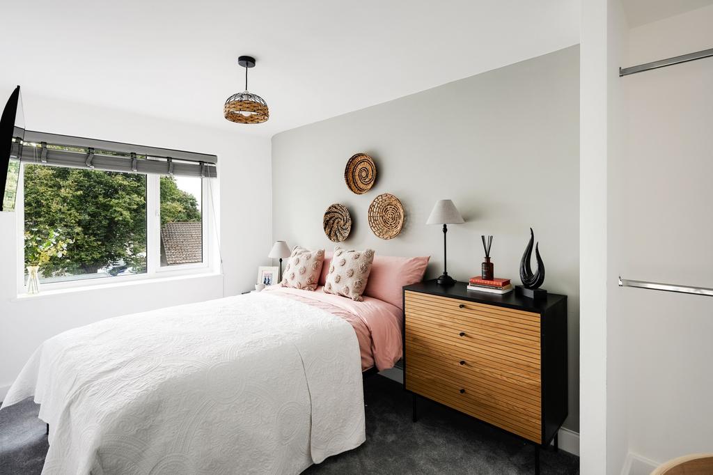 A bright and inviting double bedroom featuring ...