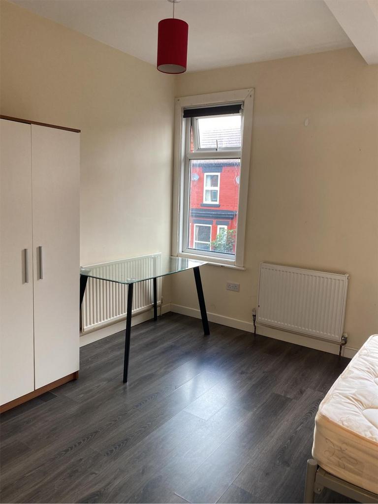 A bright and spacious double bedroom with a mod...