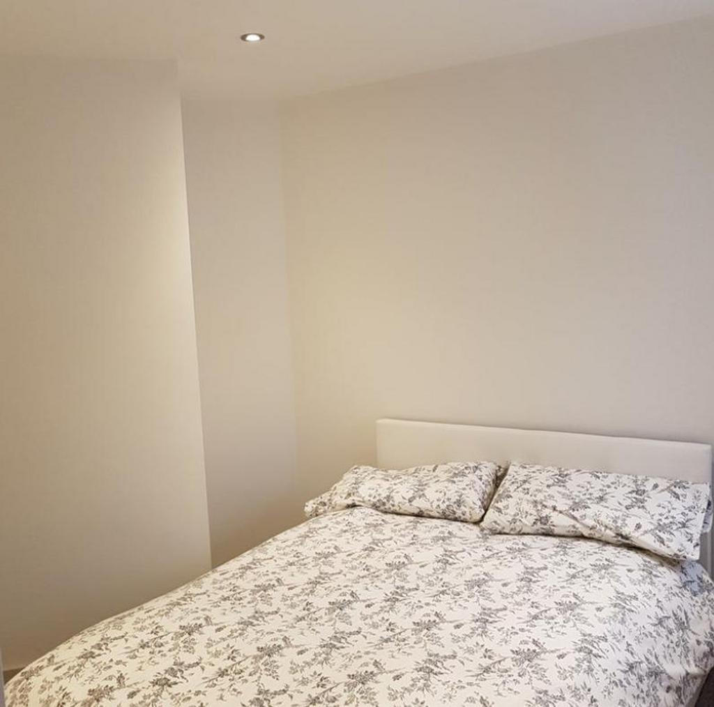 A bright and inviting double bedroom featuring ...