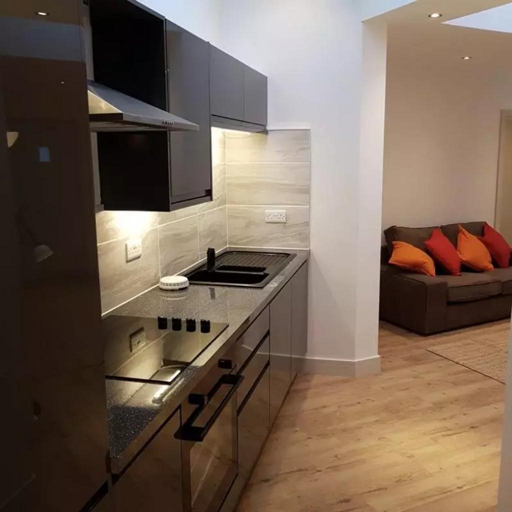 A modern kitchen featuring sleek finishes and a...