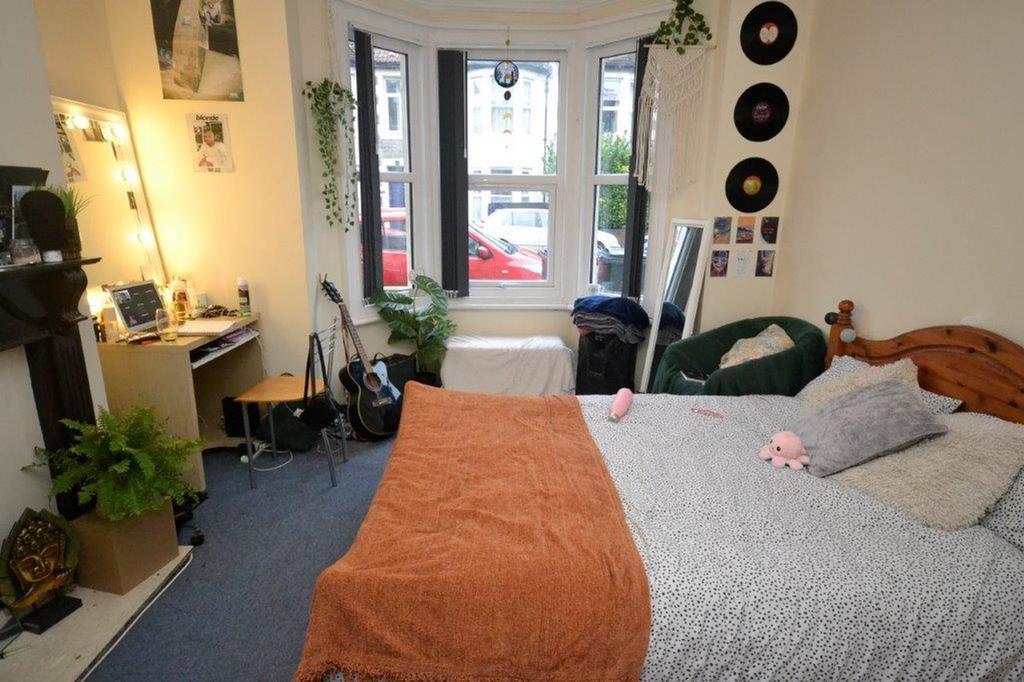 A cozy double bedroom with natural light from l...