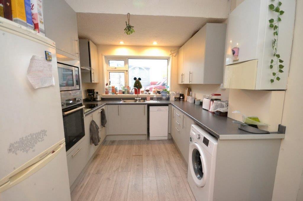 A tidy and well lit kitchen featuring modern ap...