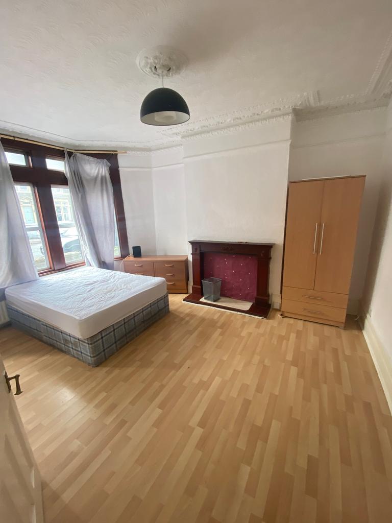 A bright and spacious double bedroom with large...