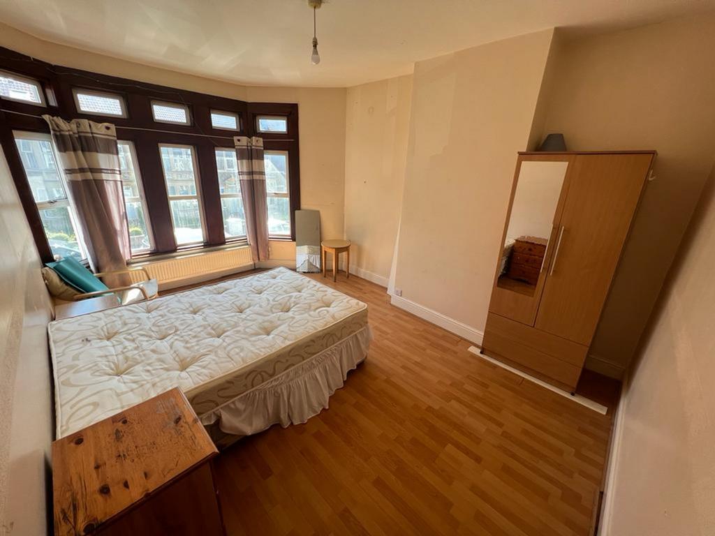 A spacious and bright double bedroom featuring ...