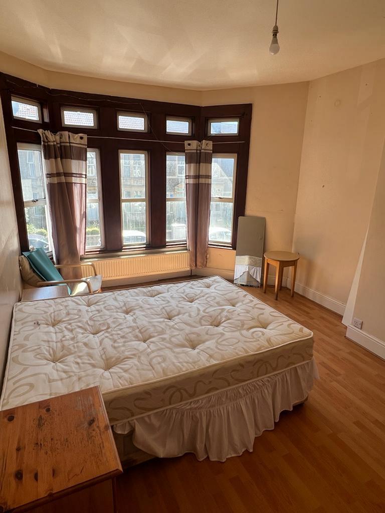 A spacious and well lit double bedroom featurin...