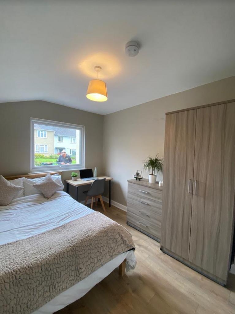 A tidy and well lit double bedroom featuring a ...