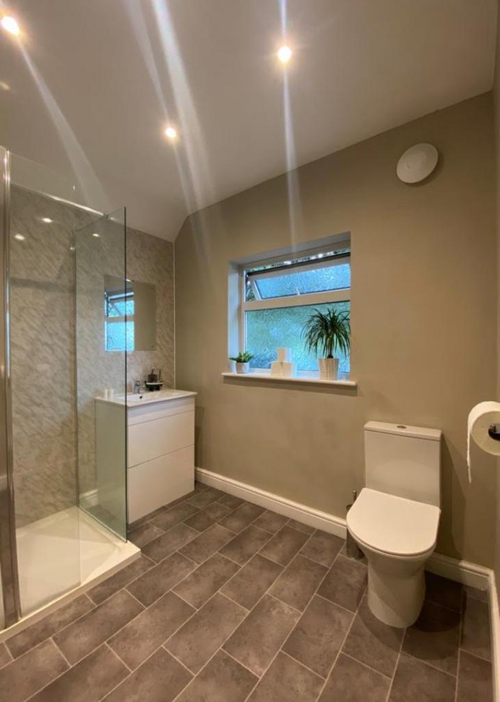 A modern and clean bathroom featuring a shower,...