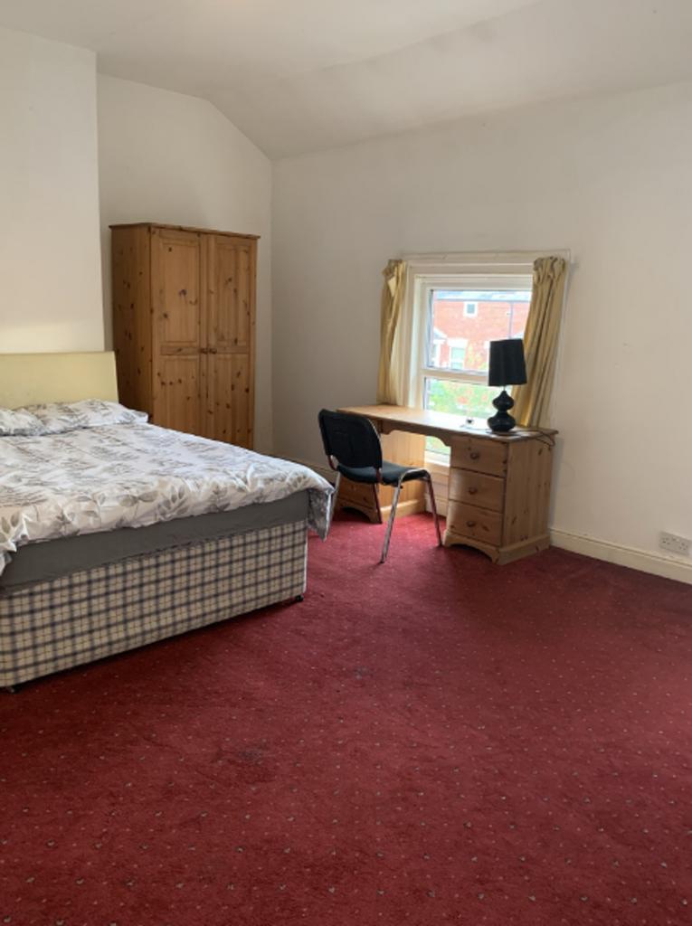 A spacious and inviting double bedroom featurin...