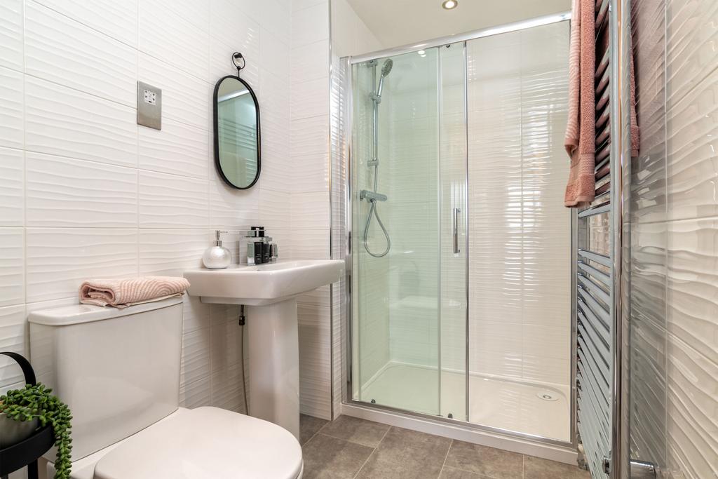 En suite shower room in three bedroom home