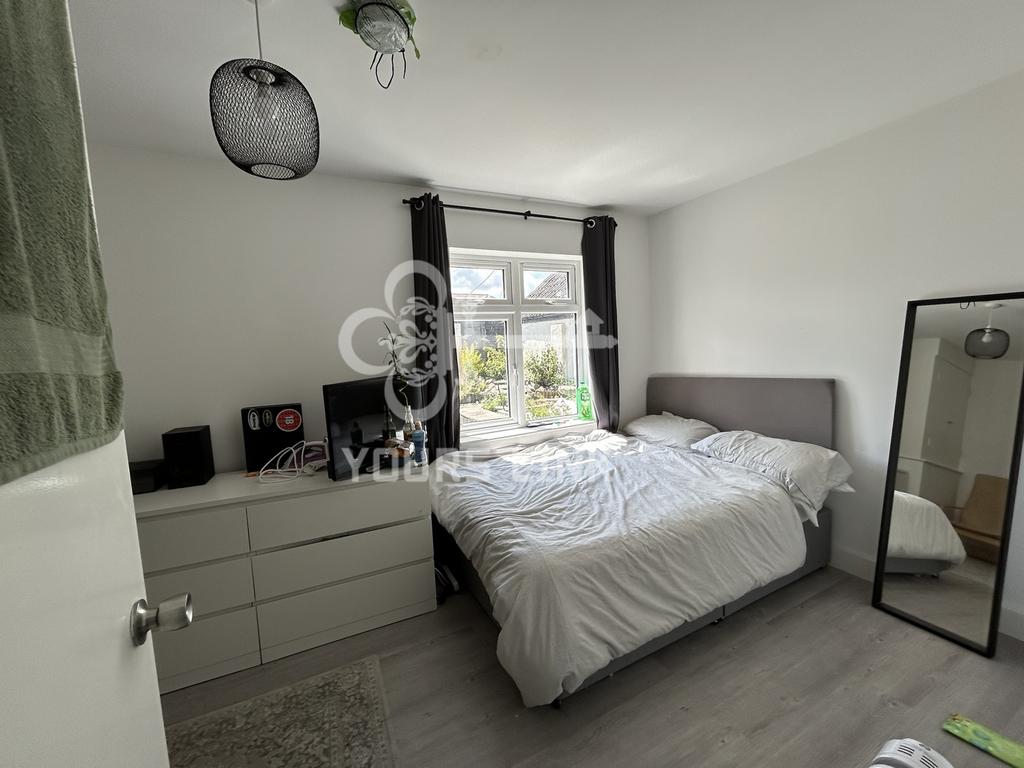 A bright and inviting double bedroom featuring ...