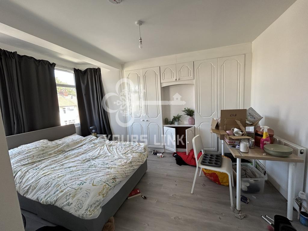 A bright double bedroom with ample natural ligh...