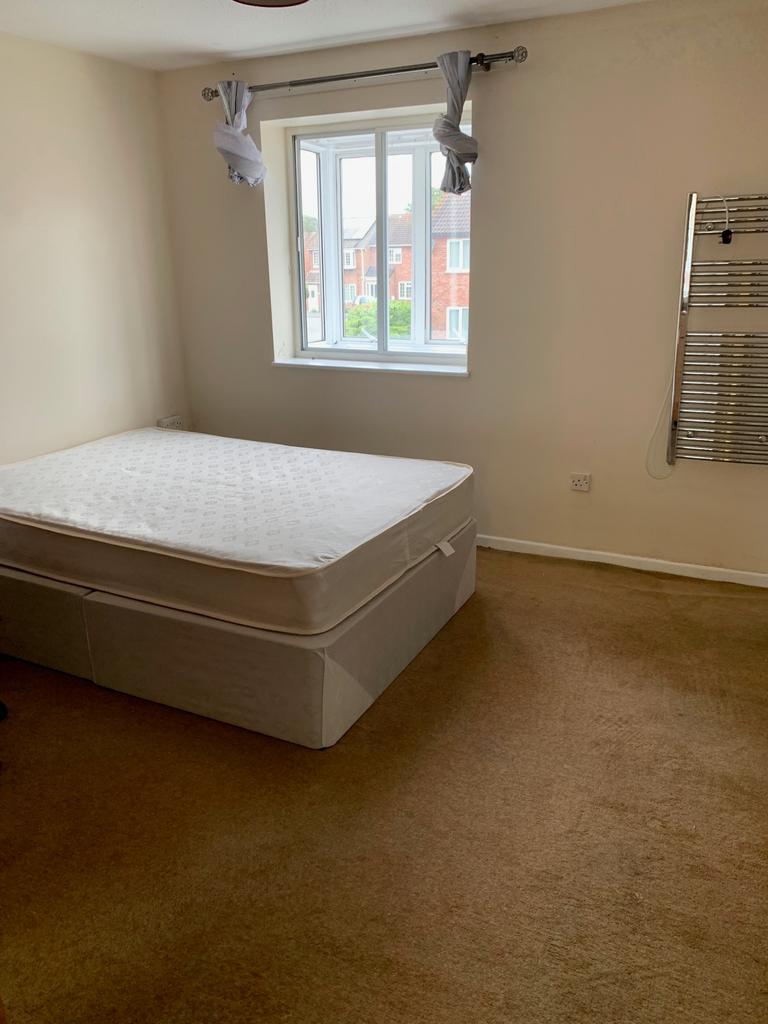 A spacious double bedroom with good natural lig...