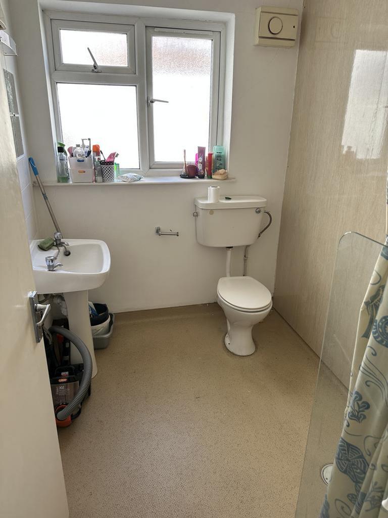 A bright and tidy bathroom featuring a shower, ...