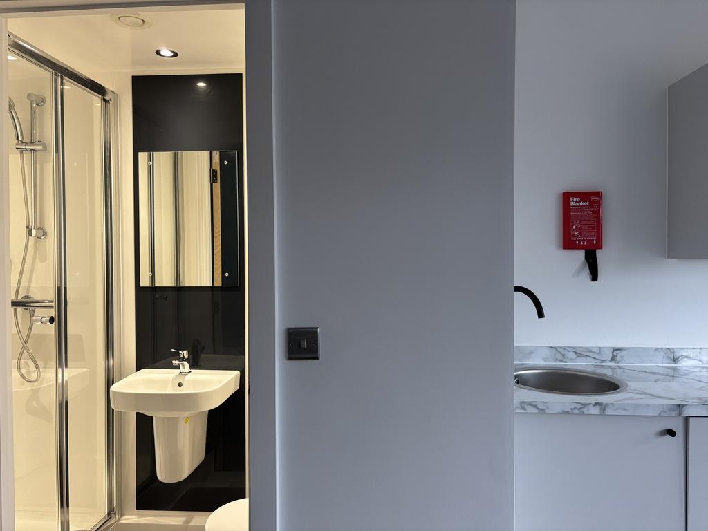 A modern and tidy bathroom featuring a spacious...