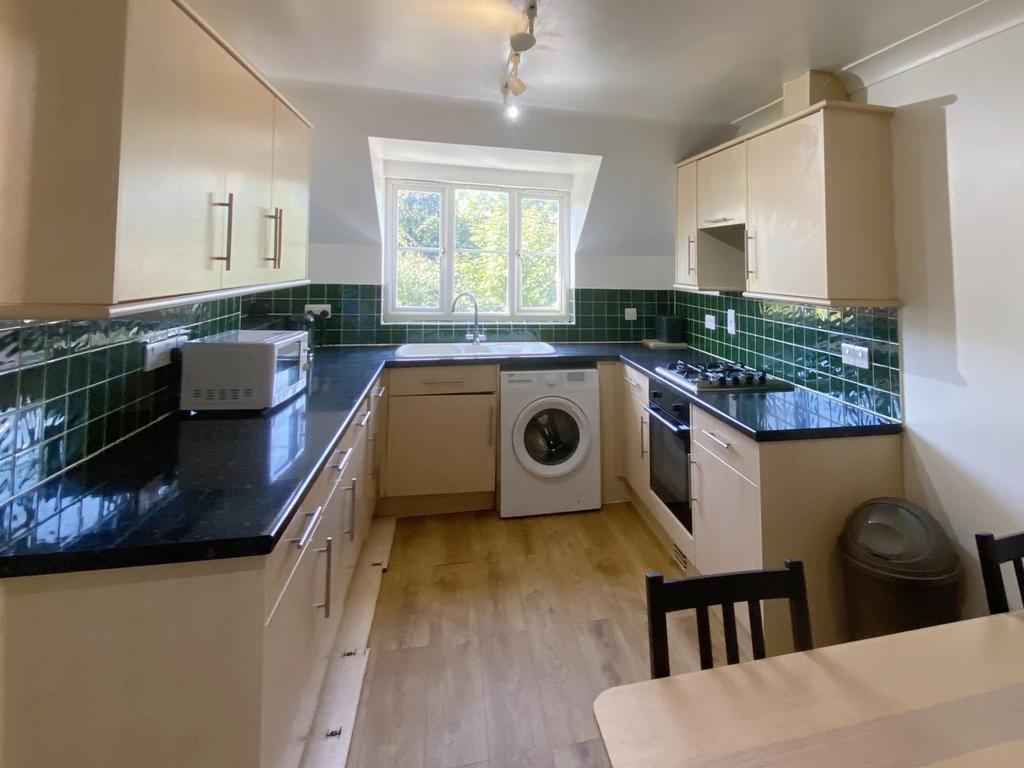 A bright and modern kitchen featuring ample sto...