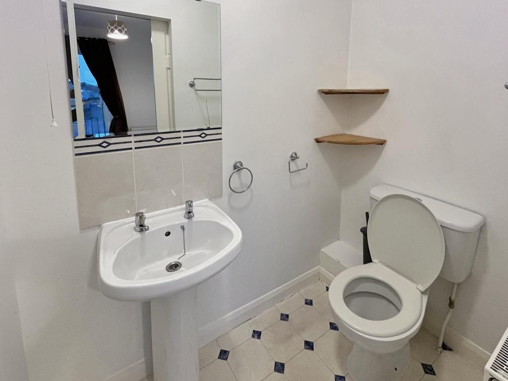 A bright and tidy bathroom featuring modern fix...