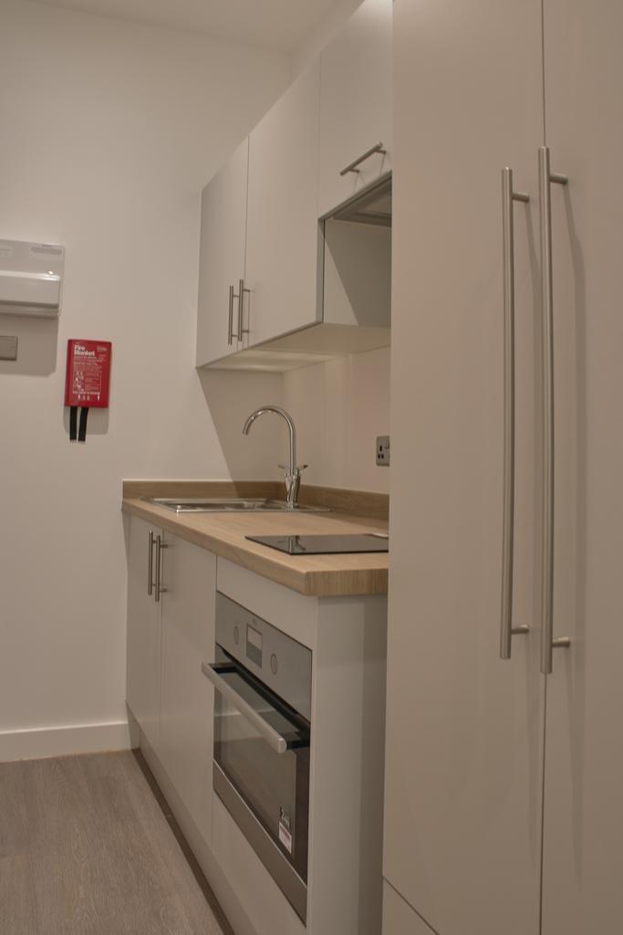 A modern and tidy kitchen featuring sleek cabin...