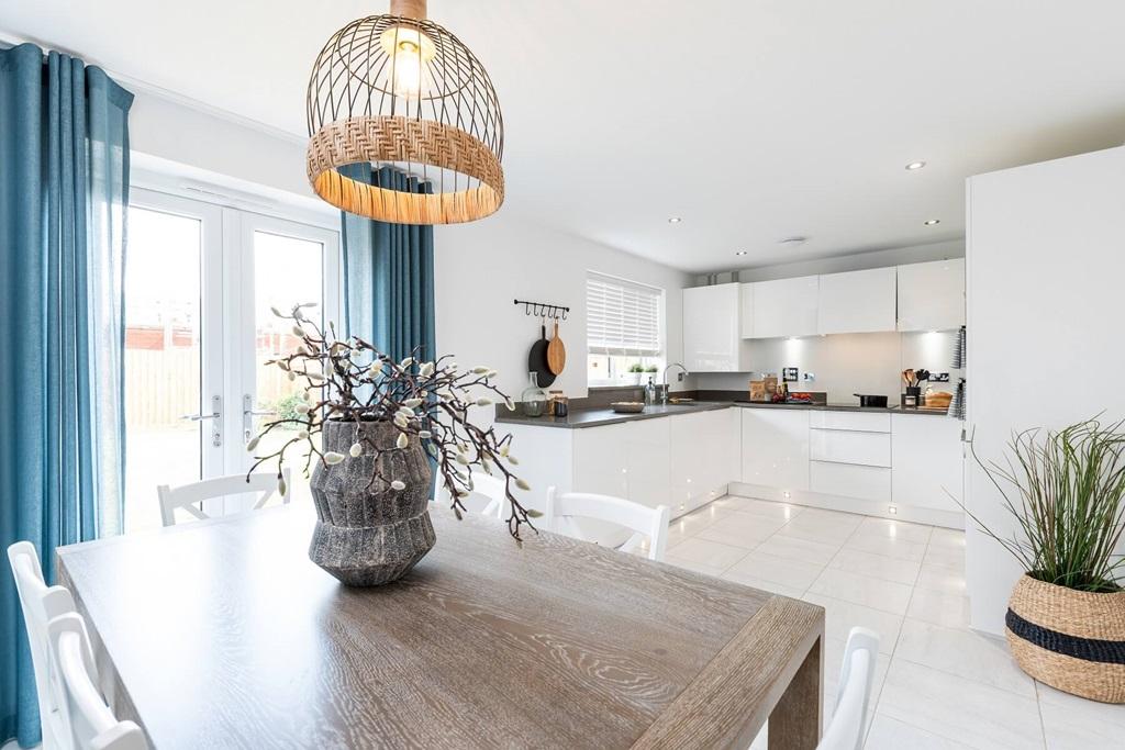 The open-plan kitchen/dining area features...