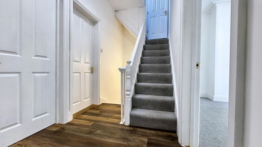 A spacious and well-maintained hallway with bri...