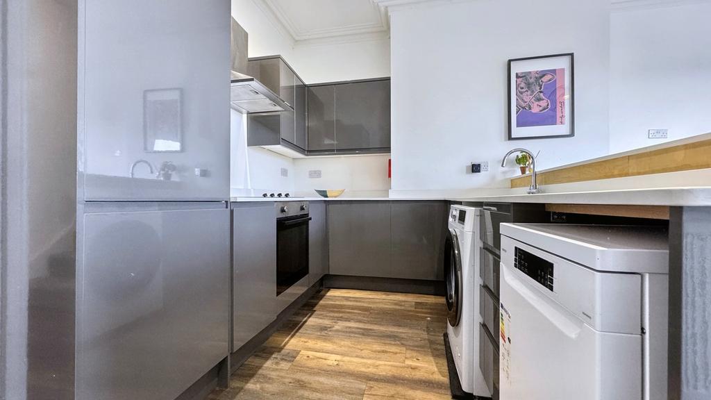 A modern and clean kitchen featuring sleek cabi...