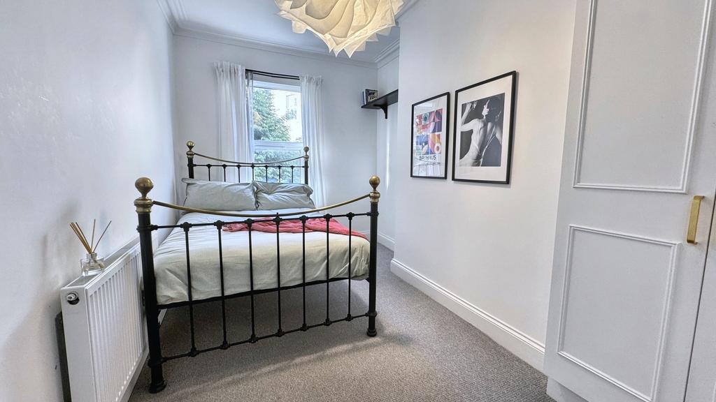 A bright and inviting double bedroom featuring ...