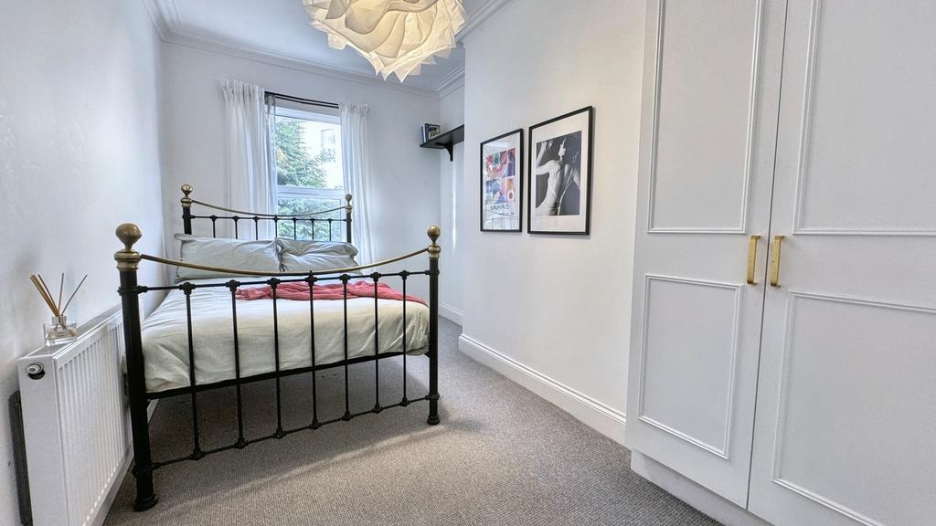A bright and inviting double bedroom featuring ...