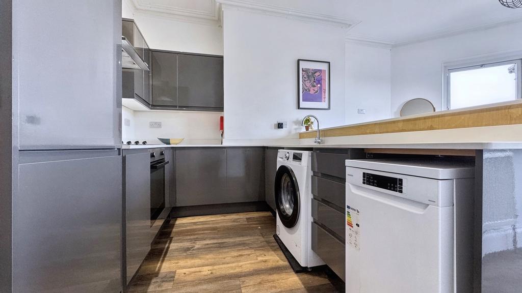 A modern and bright kitchen featuring sleek app...