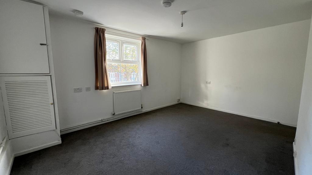 A bright and spacious double bedroom with large...