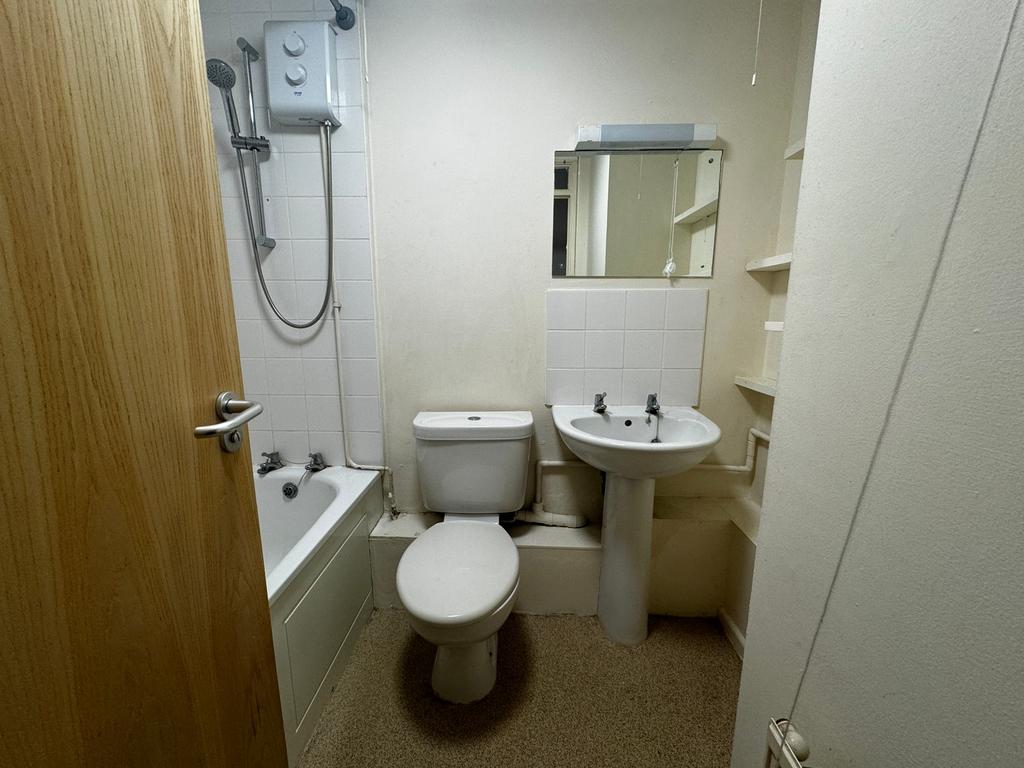 A tidy bathroom featuring both a shower and a b...