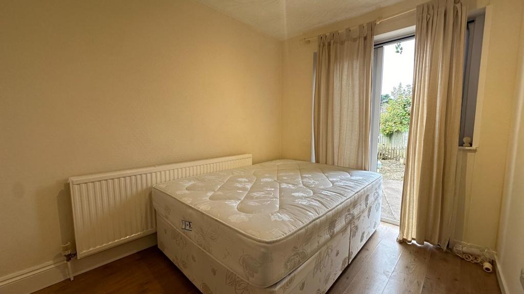 A spacious and well lit double bedroom featurin...