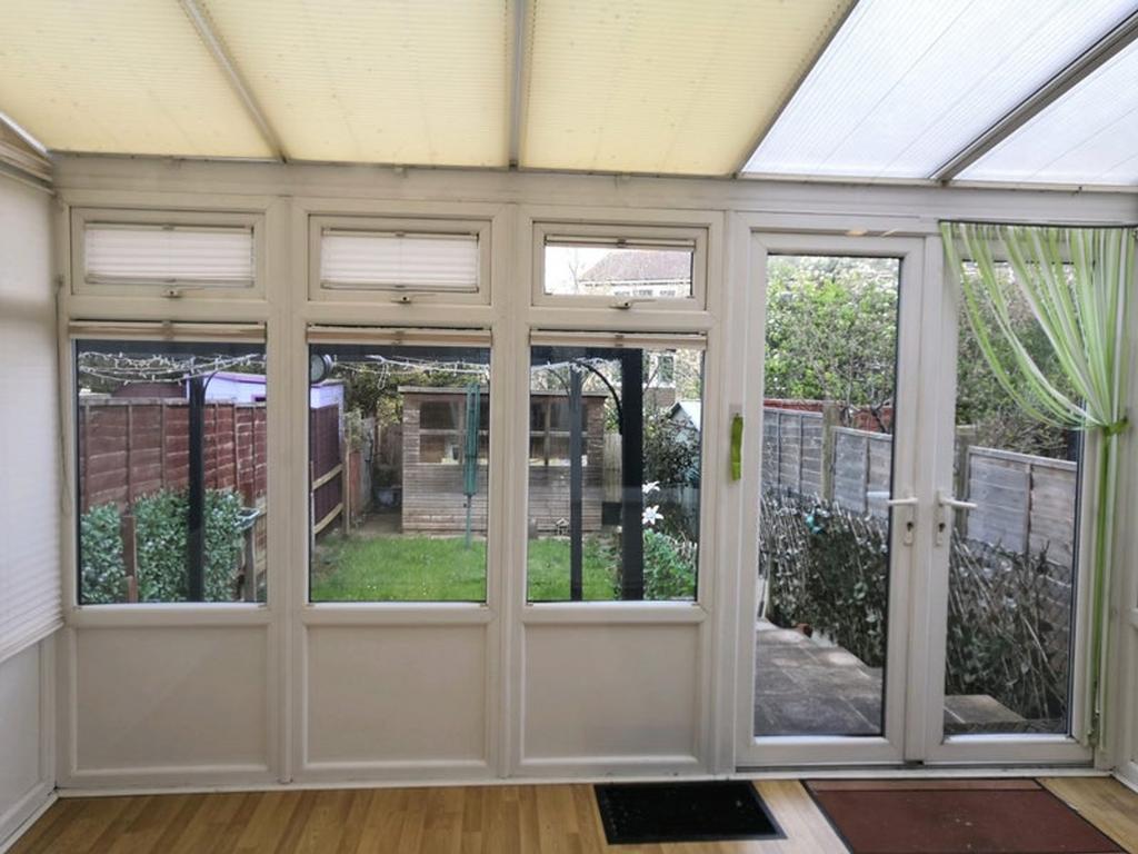 A bright and inviting garden room with ample na...