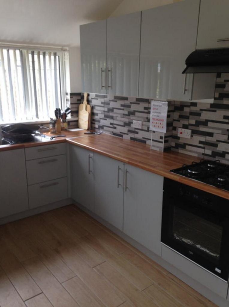 A modern and tidy kitchen featuring sleek cabin...