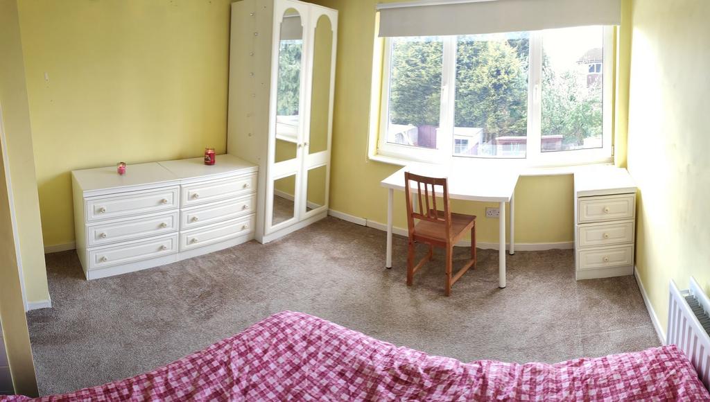 Bright and cheerful bedroom with soft yellow wa...