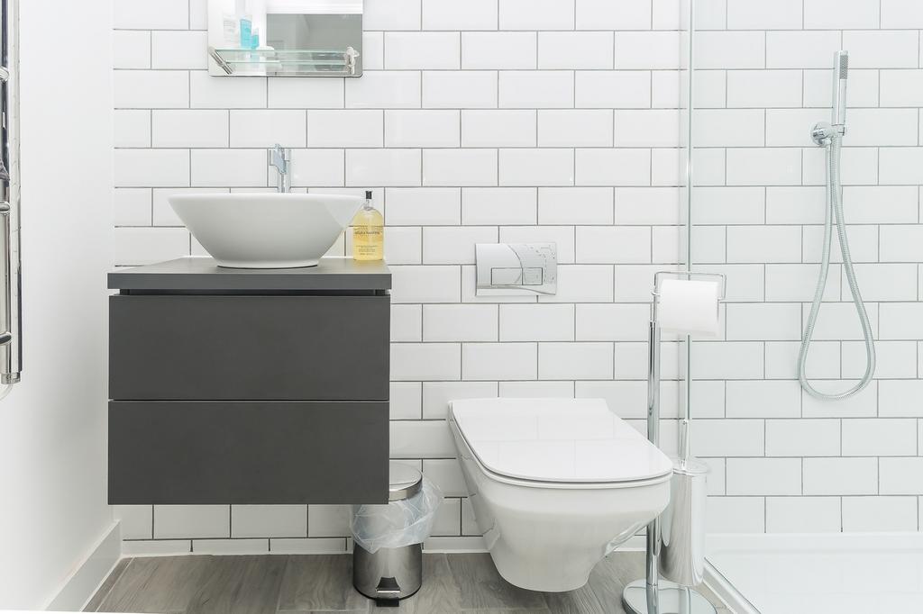 A modern and pristine bathroom featuring sleek ...