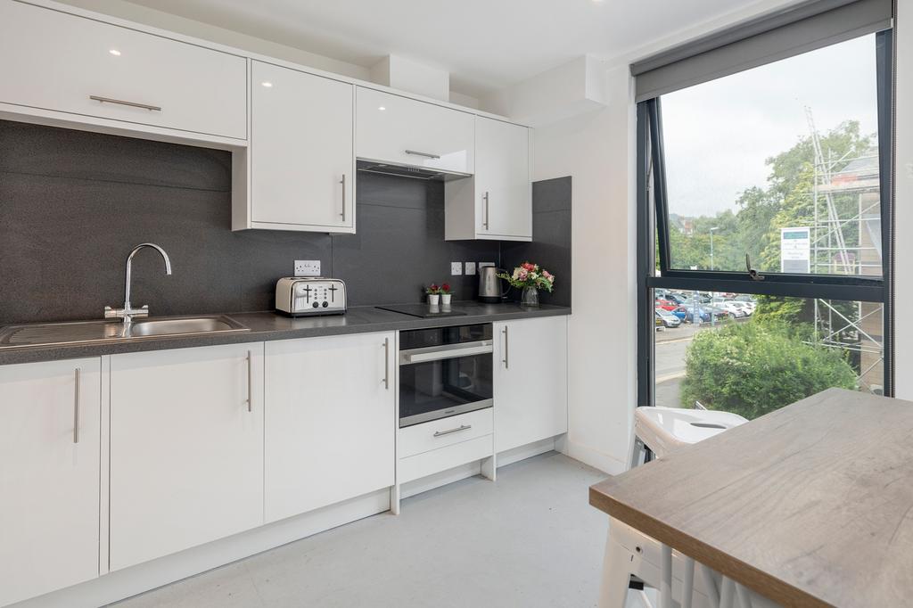 A modern and bright kitchenette with sleek fini...