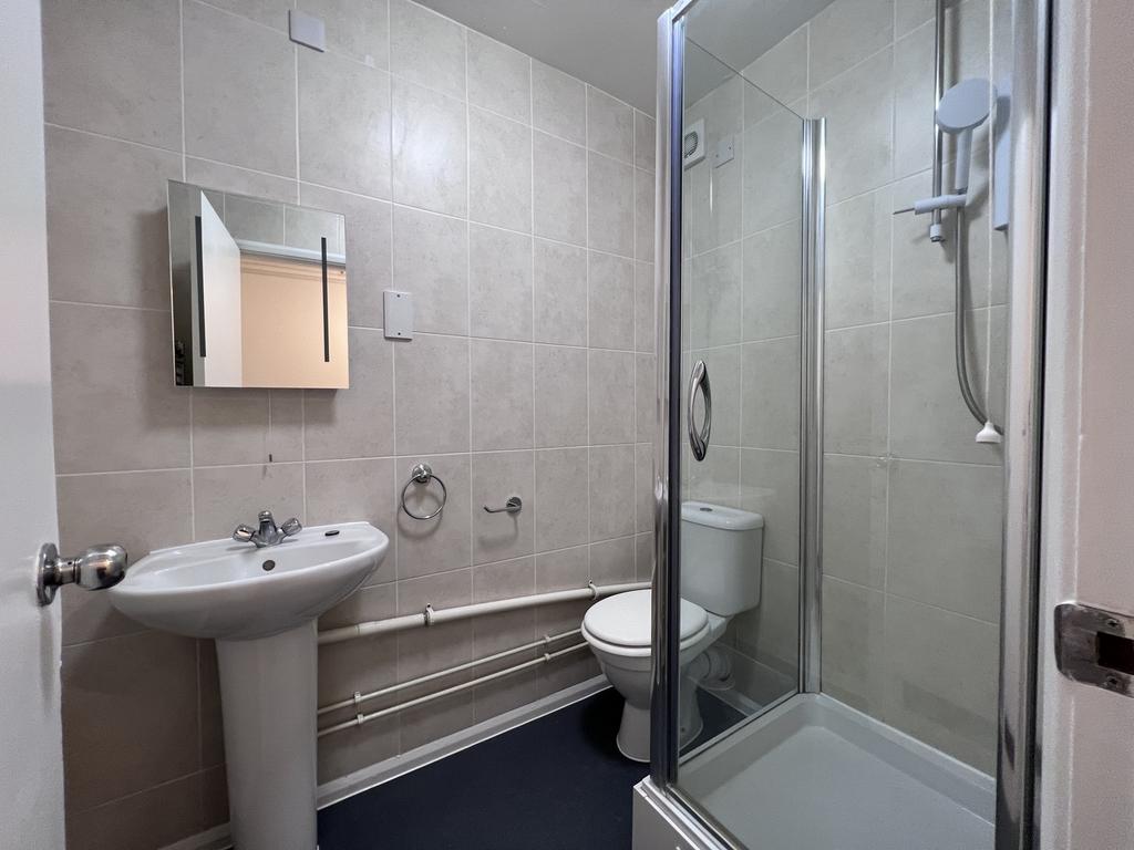 A modern and clean bathroom featuring a shower,...