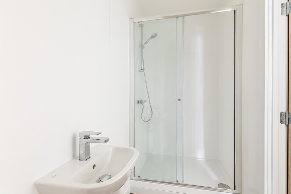 A modern and pristine bathroom featuring a spac...