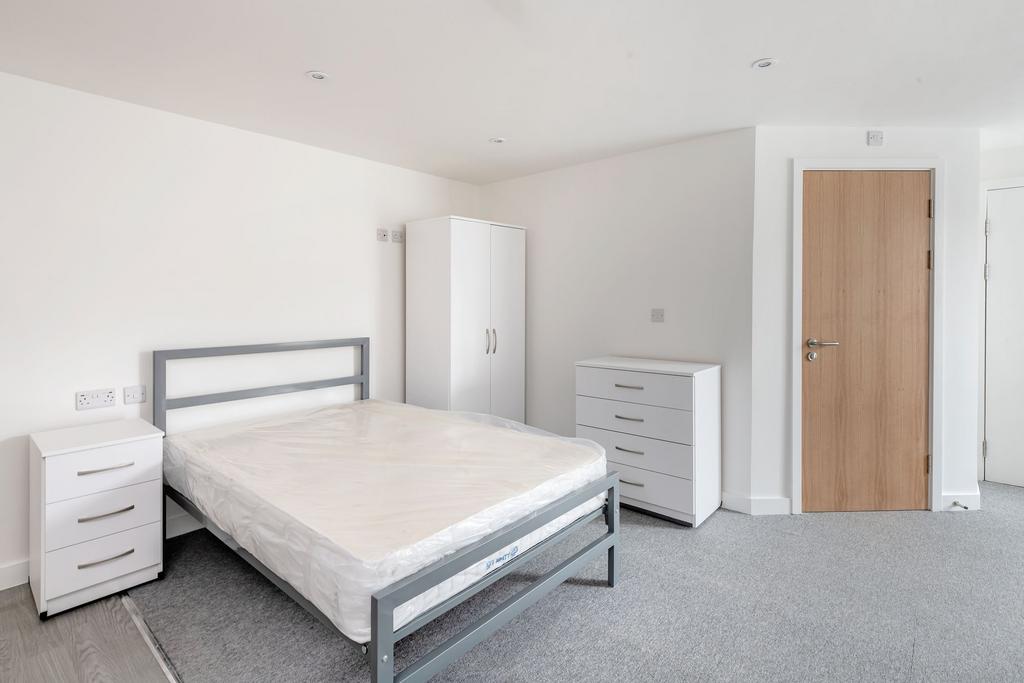 A clean and modern double bedroom featuring a m...
