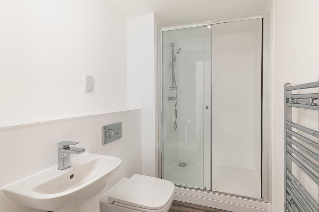 A modern and pristine bathroom featuring a slee...