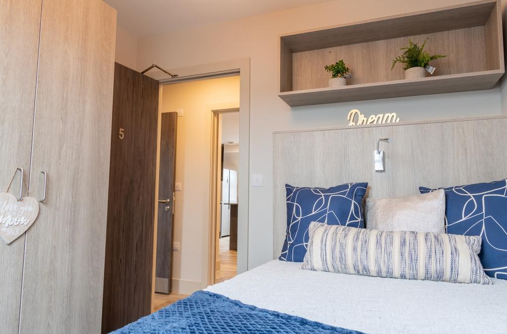 A bright and inviting double bedroom featuring ...