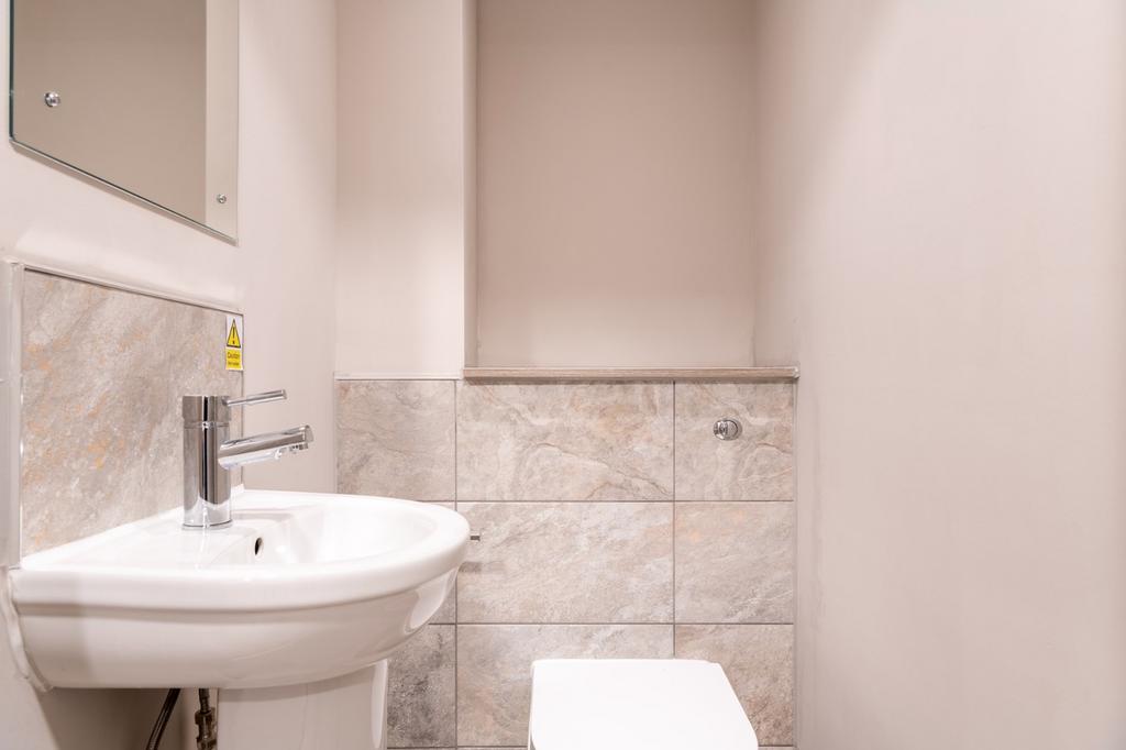 A well-maintained and tidy single toilet, featu...