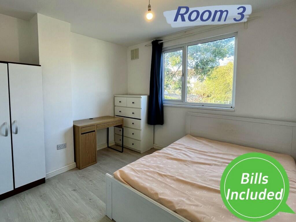 A bright and spacious double bedroom featuring ...