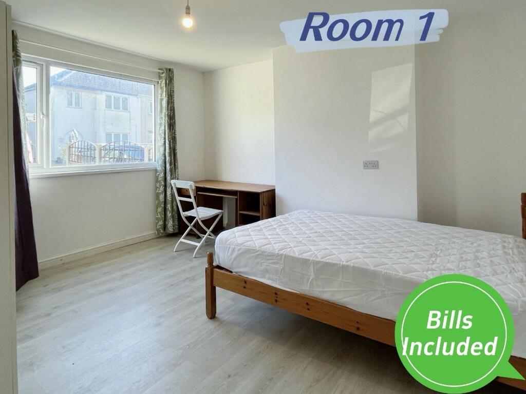 A spacious and bright double bedroom featuring ...