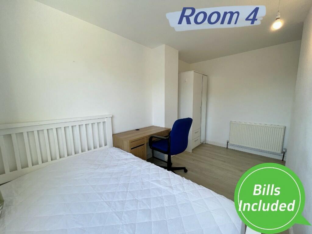 A bright and spacious double bedroom with a com...